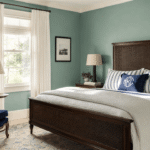 Preppy bedroom ideas 2026 featuring a cane headboard, navy striped bedding, and a monogrammed pillow in a pistachio green room.